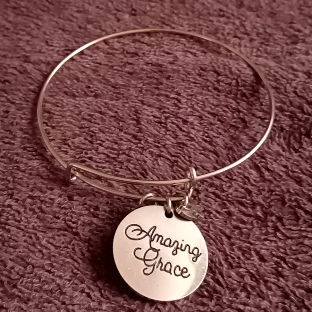 Silver color bracelet w "Amazing Grace", butterfly, n heart charms on it